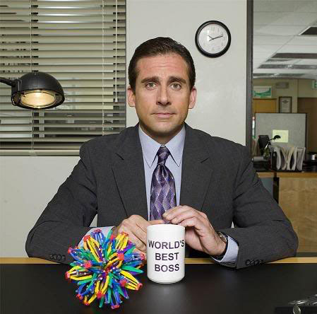 Michael Scott showing off his Worlds Best Boss mug.