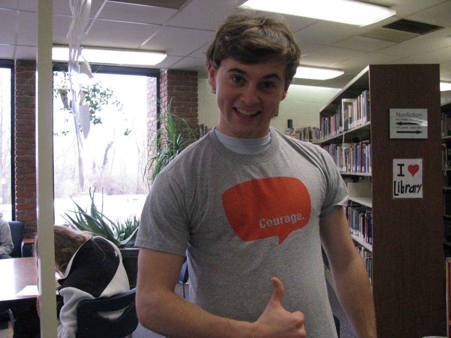 Senior Chase Beach shows off his Courage Retreat t-shirt.