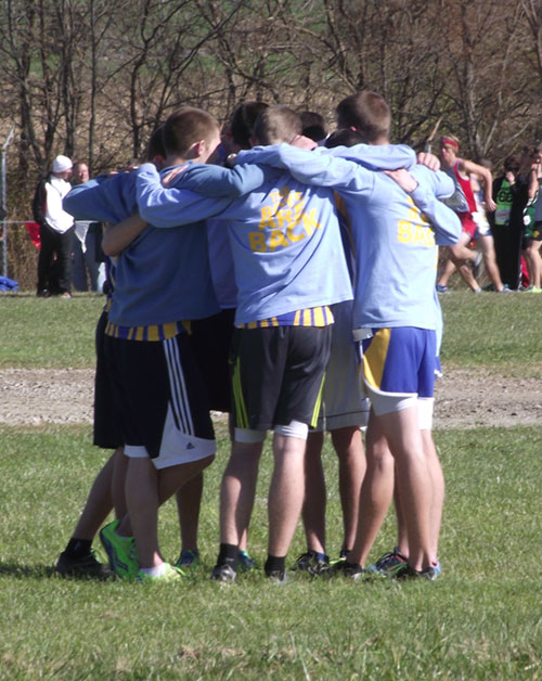 The boys team huddles up a few minutes before their race, preparing themselves with a pep talk.