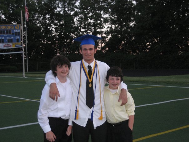 (PHOTO BY NISA SIMONS) Simons poses with his younger brothers, Chris and Daniel, After graduating in 2009.