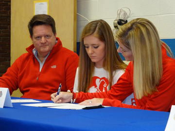 Claire, Tom, and Shannon Gilmore all sporting red on signing day.  (PHOTO BY MCKENDRICK)