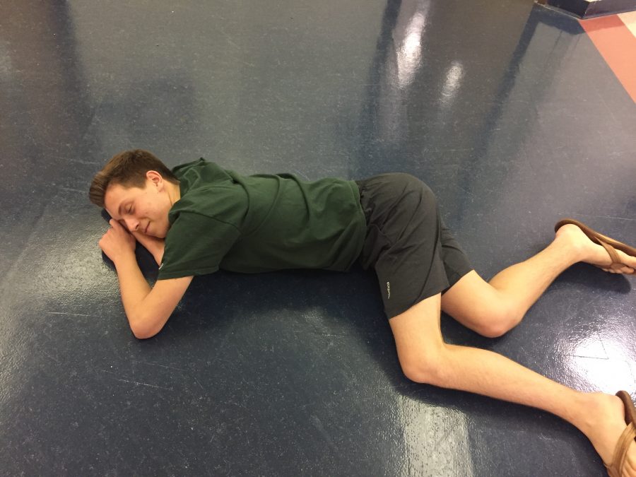 Junior Alex Wilson naps in the middle of the hallway. Who knows what hes dreaming about? (PHOTO BY KAPCAR)