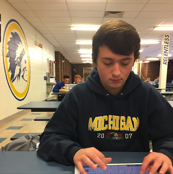Driggett carefully formulating his fantasy lineup while repping Michigan gear (PHOTO BY CAMPBELL)