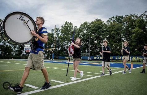 Members of the banding entering on to the field for the halftime show for the first home game of the 2019 year (PHOTO BY Four Js Photography)