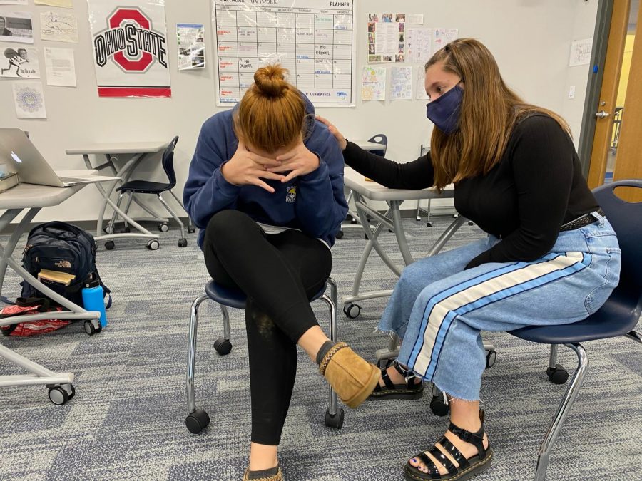 Junior Cricket Collister consoles senior Olivia Simpson as she is stressed about college applications.